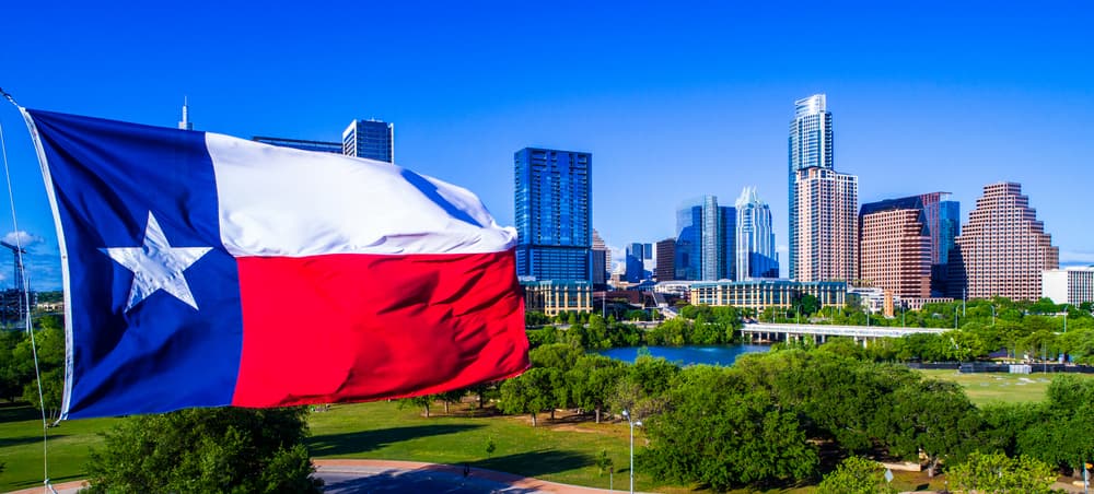 Tx Flag with Austin Downtown in the background